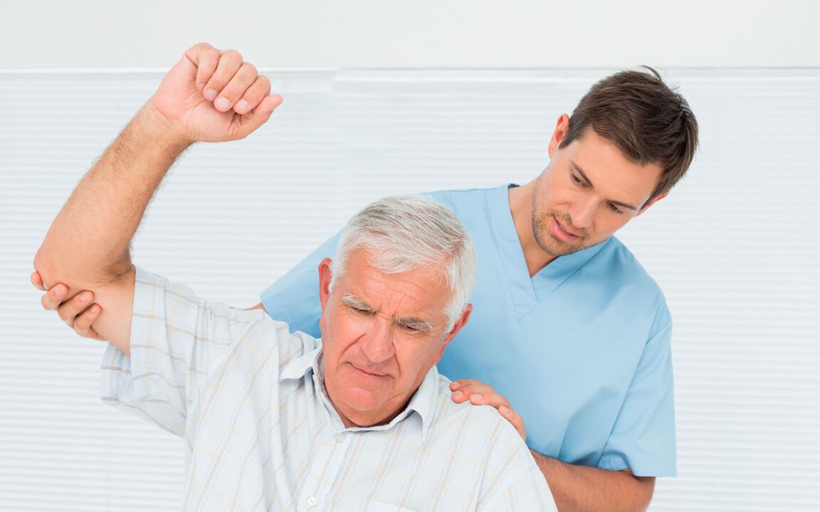 Doctor examines patient with shoulder arthritis